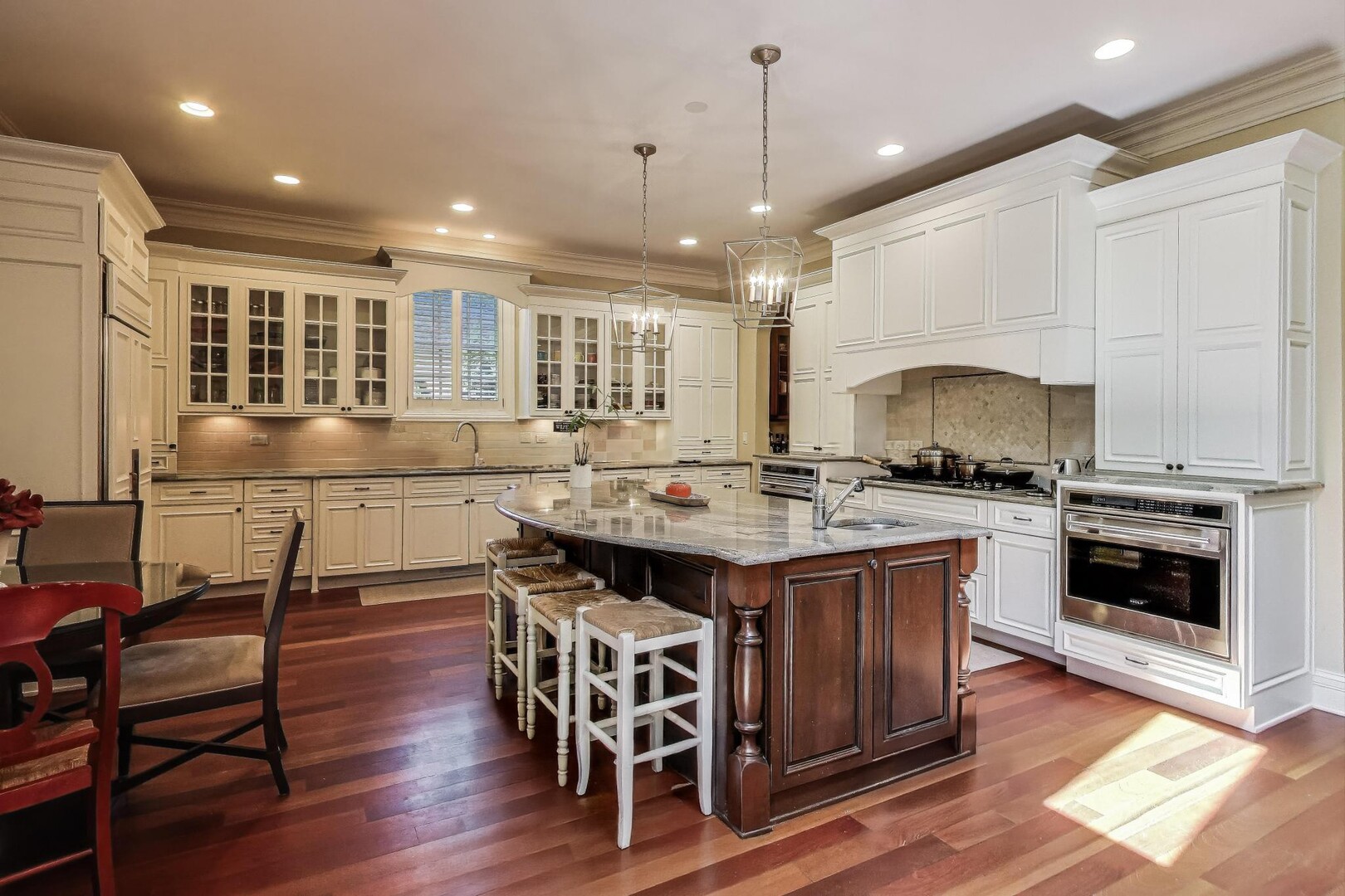 901 Pontiac Road Wilmette, IL 60091 - Photo 9 of 35 a kitchen with stainless steel appliances granite countertop a stove a sink dishwasher a dining table and chairs with wooden floor