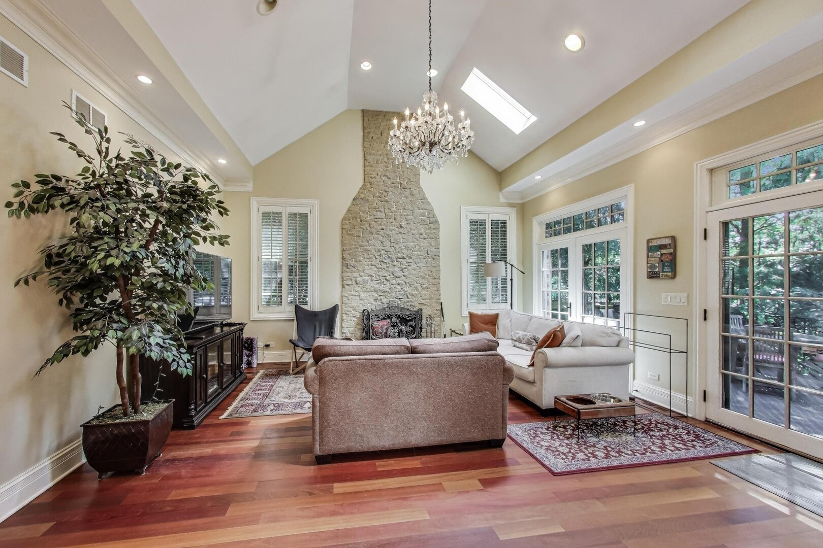 901 Pontiac Road Wilmette, IL 60091 - Photo 10 of 35 a living room with furniture a chandelier and a fireplace