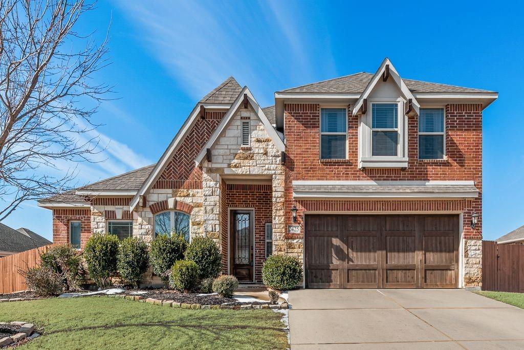 2425 Moon Dance Lane Midlothian, TX 76065 - Photo 1 of 1 a front view of a house with garden