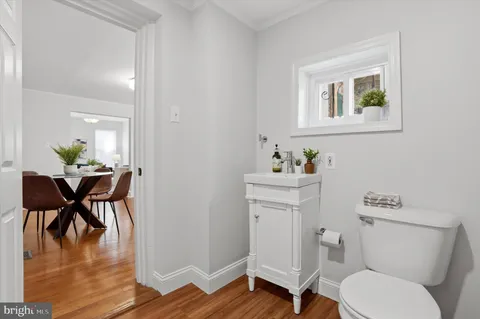 a bathroom with a toilet a sink and a mirror