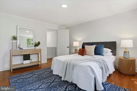 a bedroom with a bed and a potted plant