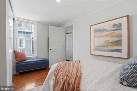 a bedroom with furniture and a window