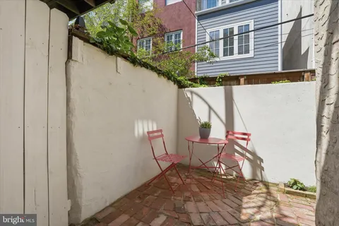 a outdoor view of a house with a lounge chair