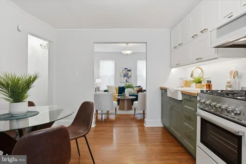 a kitchen with a table chairs and a stove