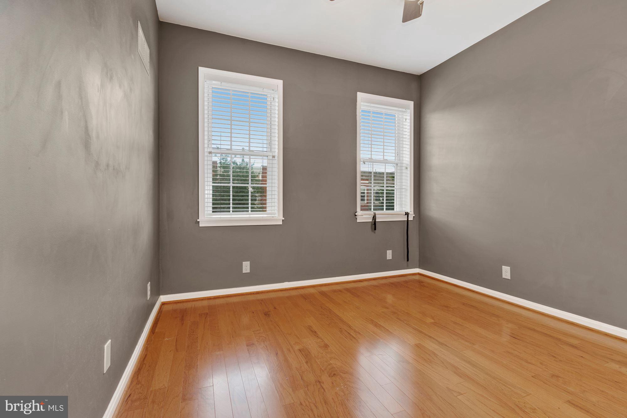 1445 Andre Street Baltimore, MD 21230 - Photo 13 of 22 a view of an empty room with wooden floor and a window