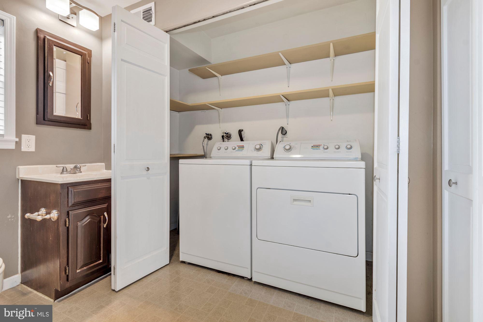 1445 Andre Street Baltimore, MD 21230 - Photo 16 of 22 a utility room with cabinets washer and dryer