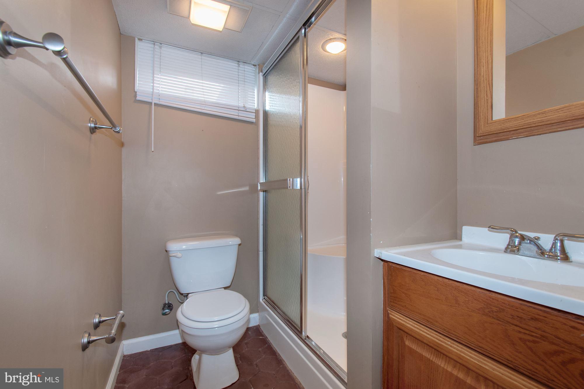 1445 Andre Street Baltimore, MD 21230 - Photo 19 of 22 a bathroom with a toilet sink and shower
