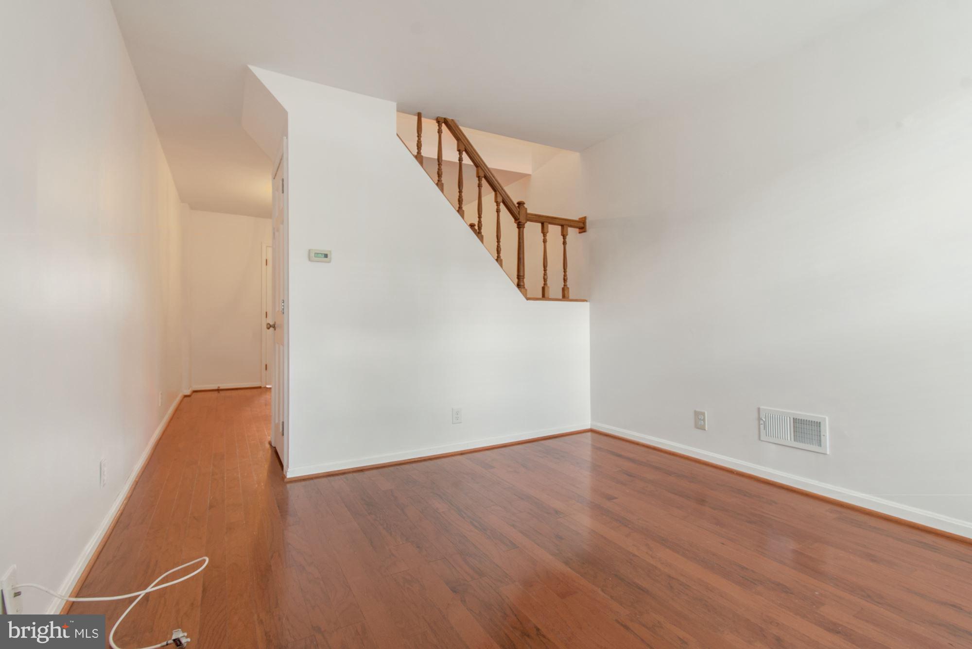 1445 Andre Street Baltimore, MD 21230 - Photo 4 of 22 an empty room with wooden floor and windows