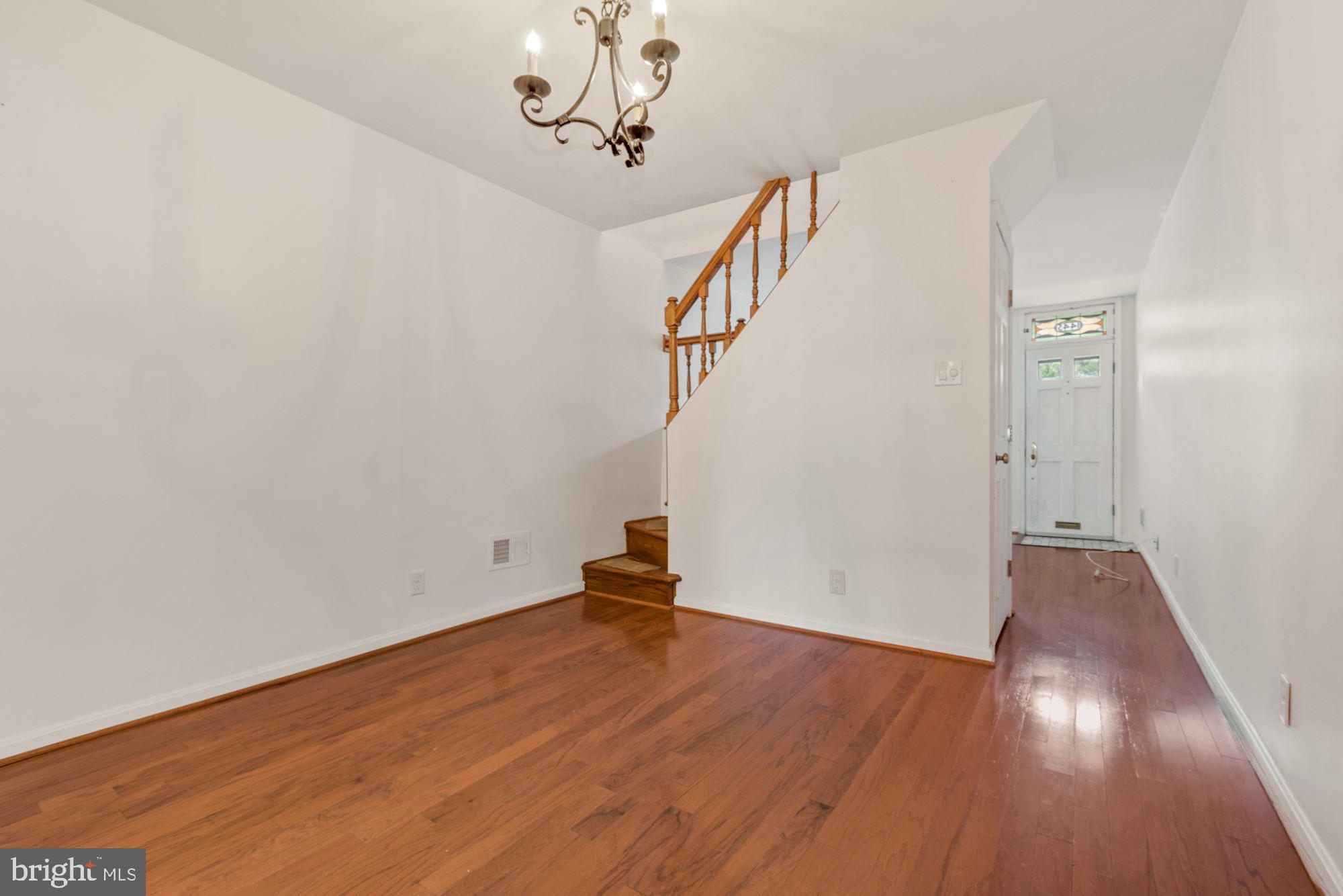 1445 Andre Street Baltimore, MD 21230 - Photo 6 of 22 a view of empty room with wooden floor and stairs