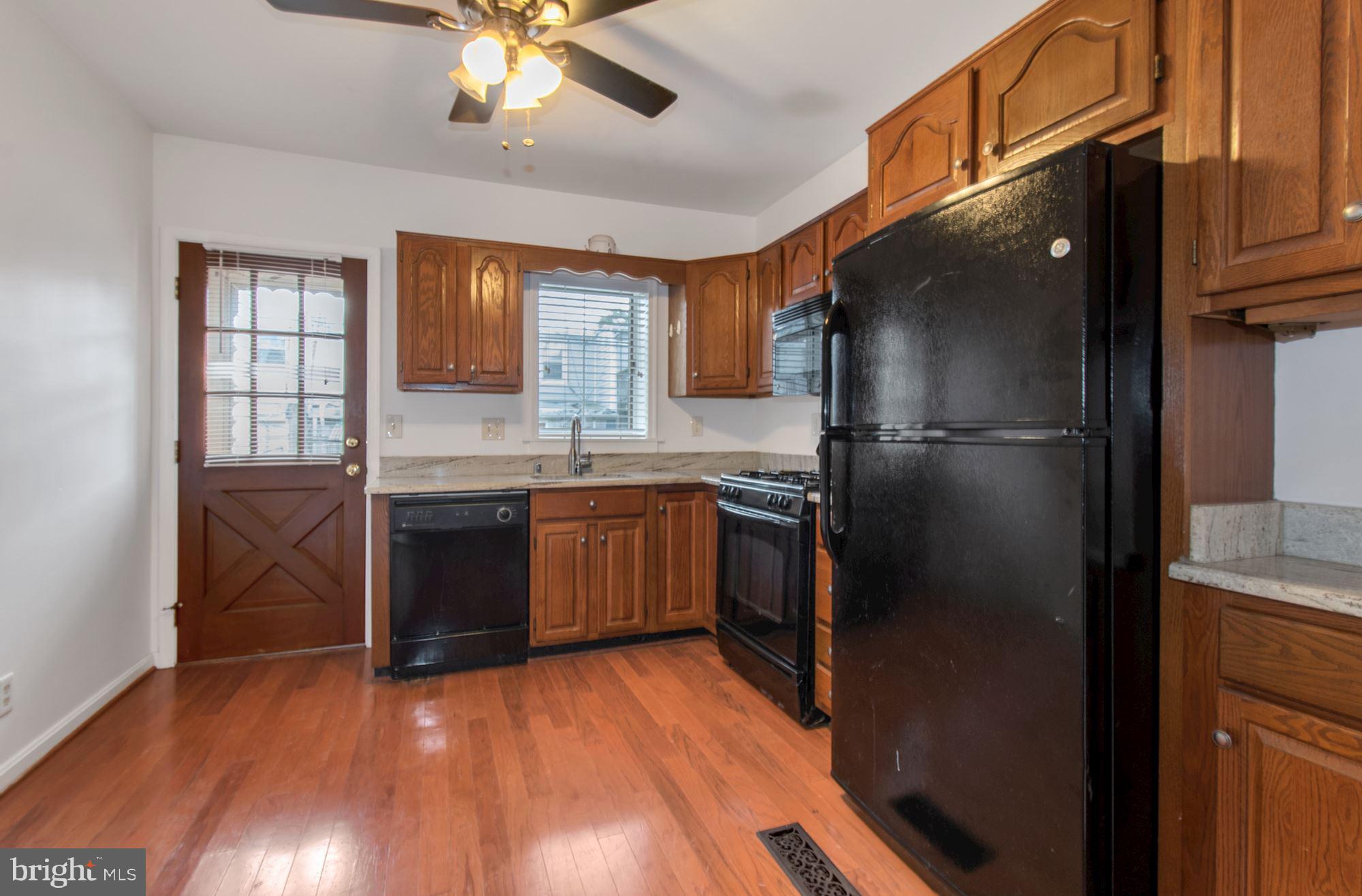 1445 Andre Street Baltimore, MD 21230 - Photo 8 of 22 a kitchen with a refrigerator and a sink