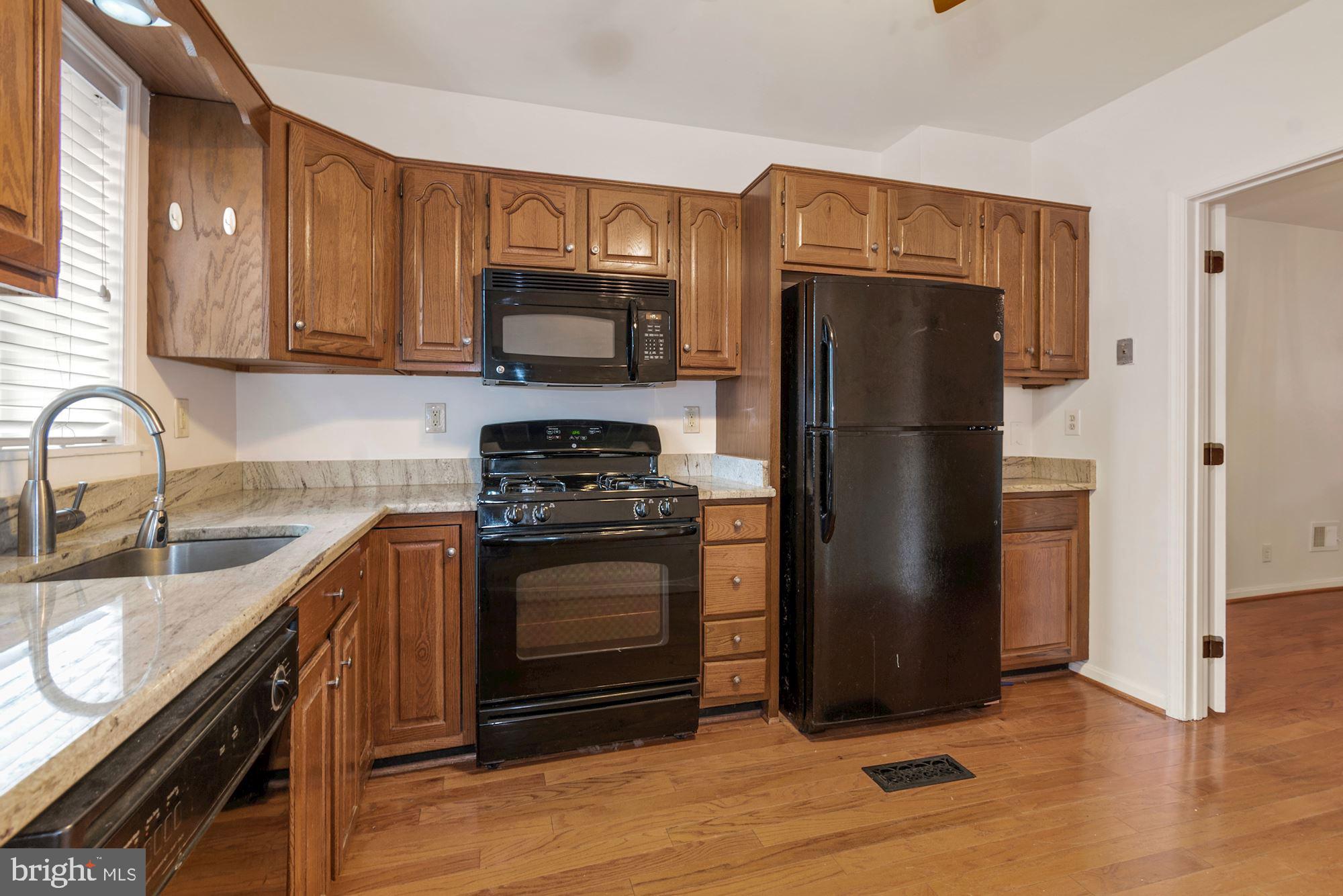 1445 Andre Street Baltimore, MD 21230 - Photo 9 of 22 a kitchen with stainless steel appliances granite countertop a refrigerator stove and sink