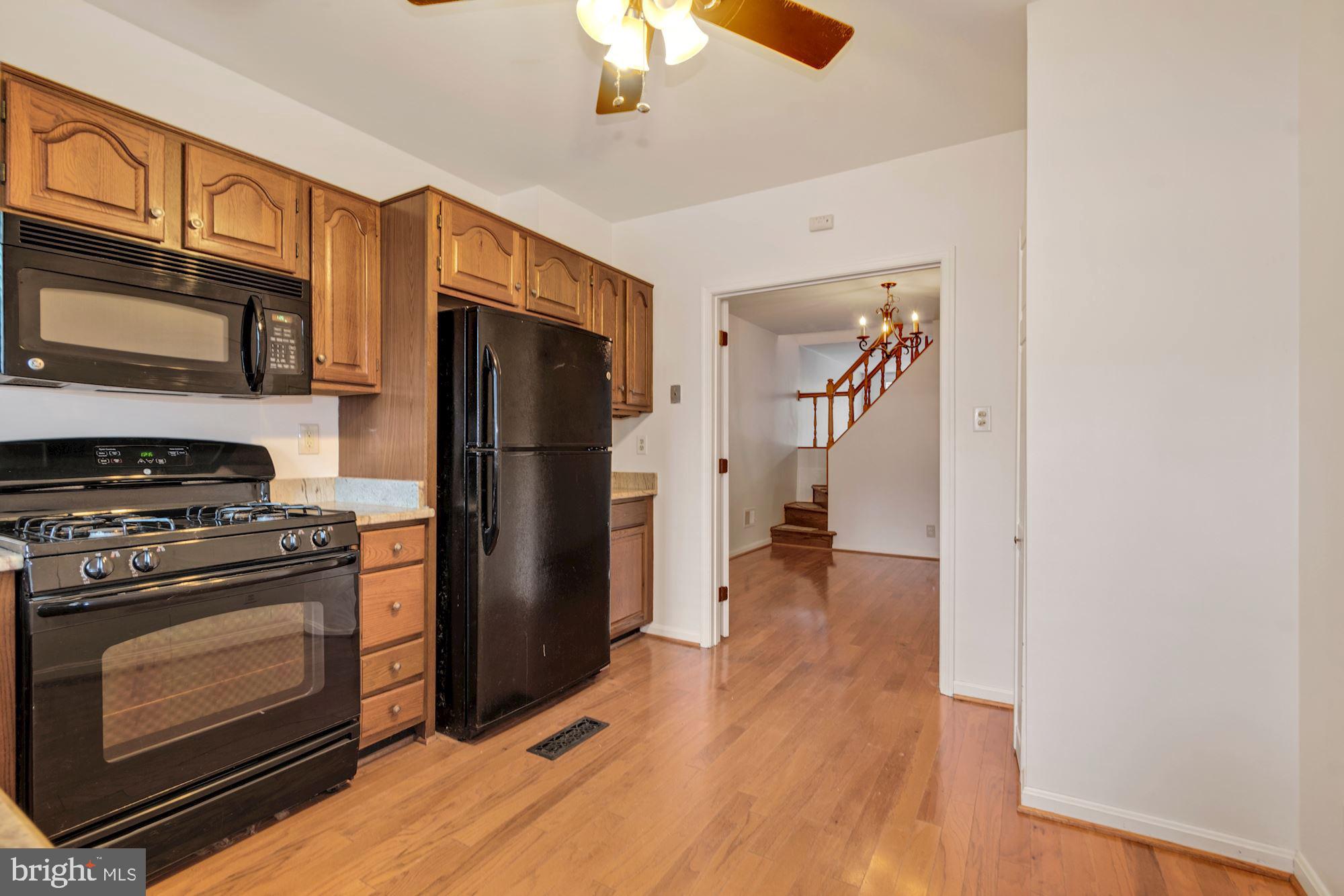 1445 Andre Street Baltimore, MD 21230 - Photo 10 of 22 a kitchen with a stove refrigerator and a microwave