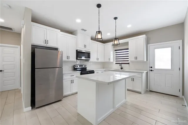 a kitchen with a refrigerator a sink and dishwasher