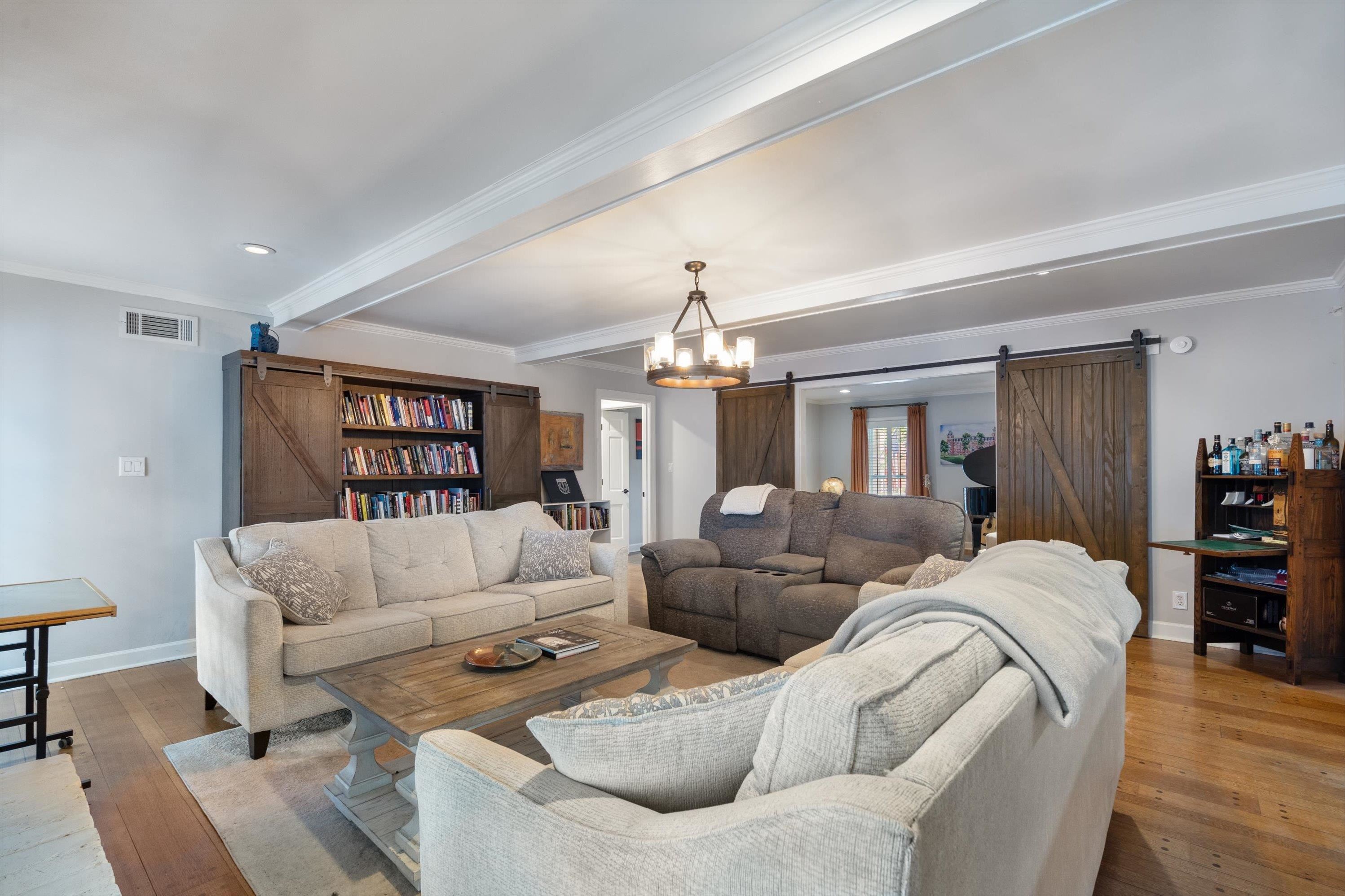 839 Reddoch Street Memphis, TN 38119 - Photo 13 of 36 a living room with furniture or couch and a chandelier