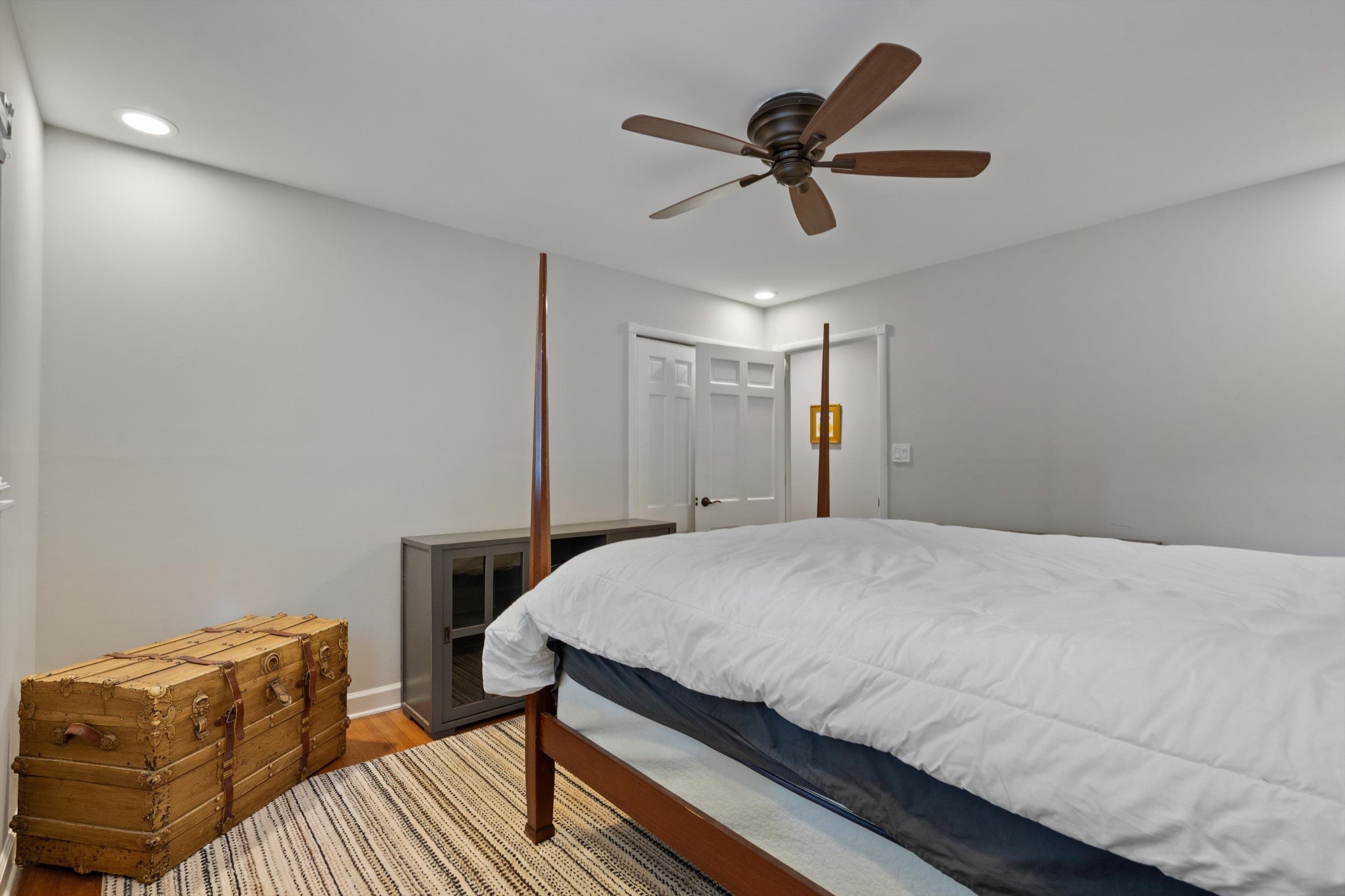 839 Reddoch Street Memphis, TN 38119 - Photo 17 of 36 a bedroom with a bed and a chandelier