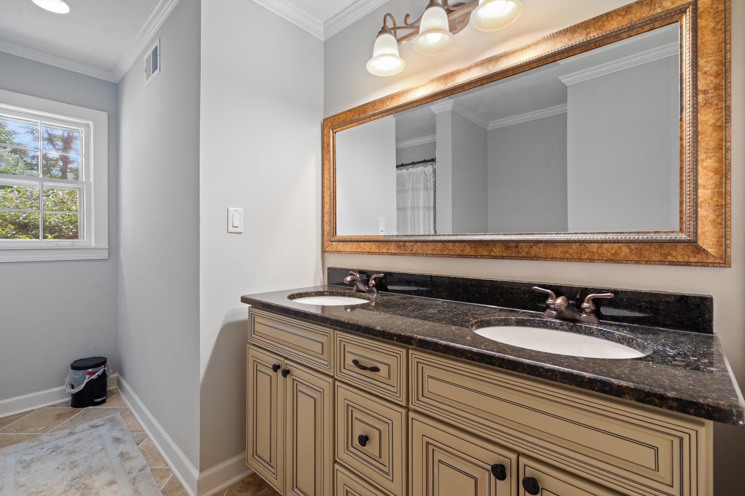 839 Reddoch Street Memphis, TN 38119 - Photo 18 of 36 a bathroom with a granite countertop sink a mirror and a