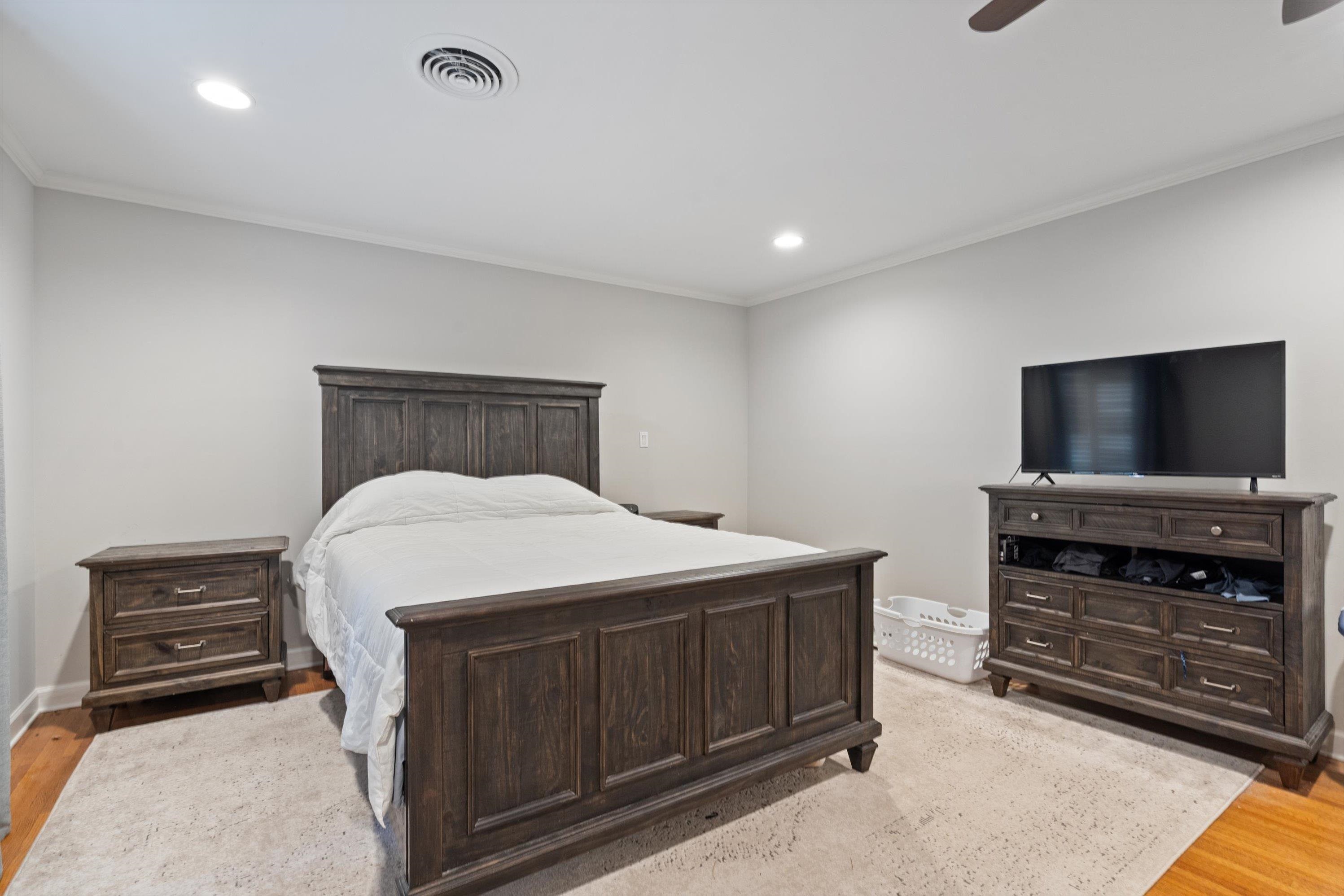 839 Reddoch Street Memphis, TN 38119 - Photo 22 of 36 a bedroom with a bed and a flat screen tv