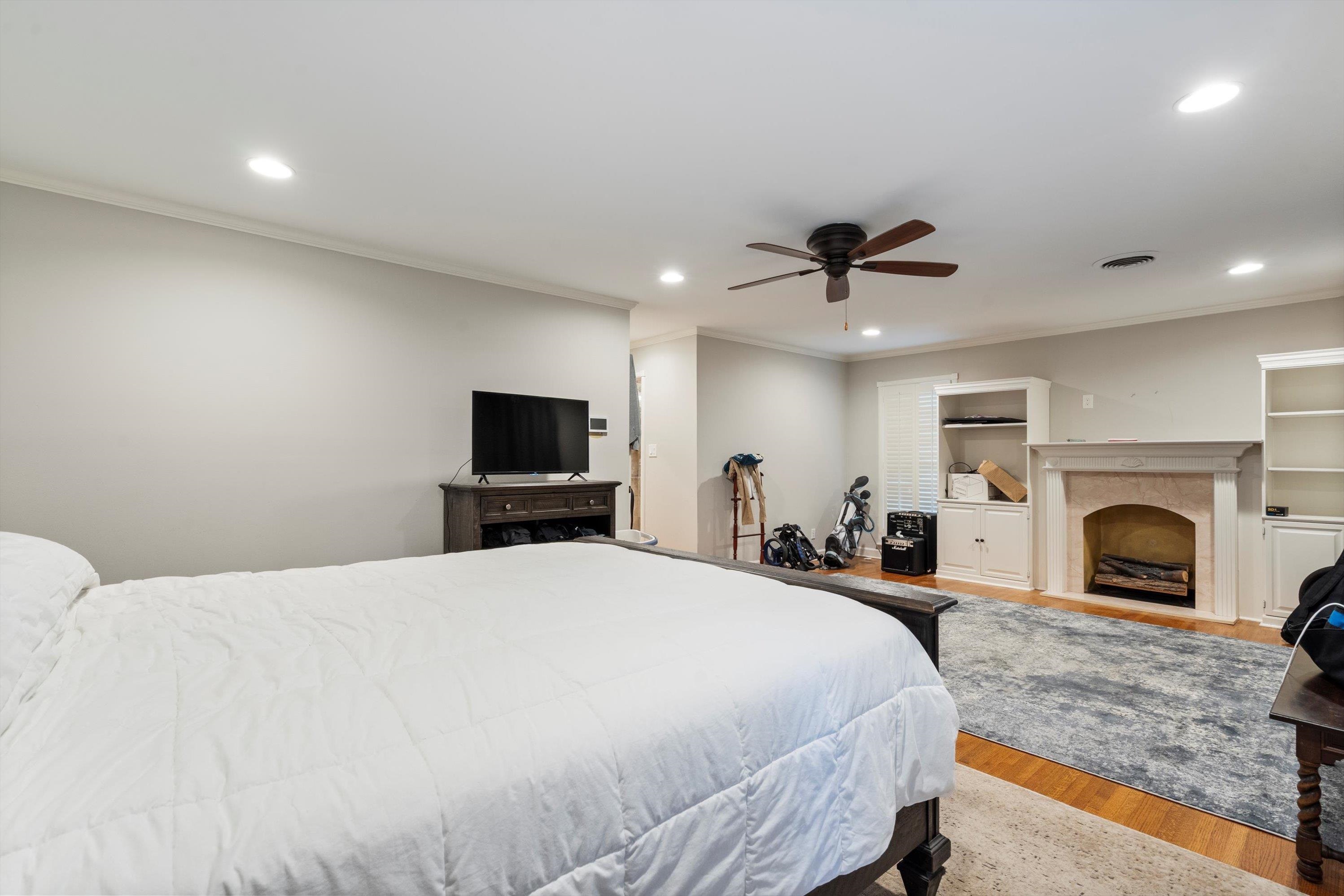 839 Reddoch Street Memphis, TN 38119 - Photo 24 of 36 a bedroom with a bed and a fireplace