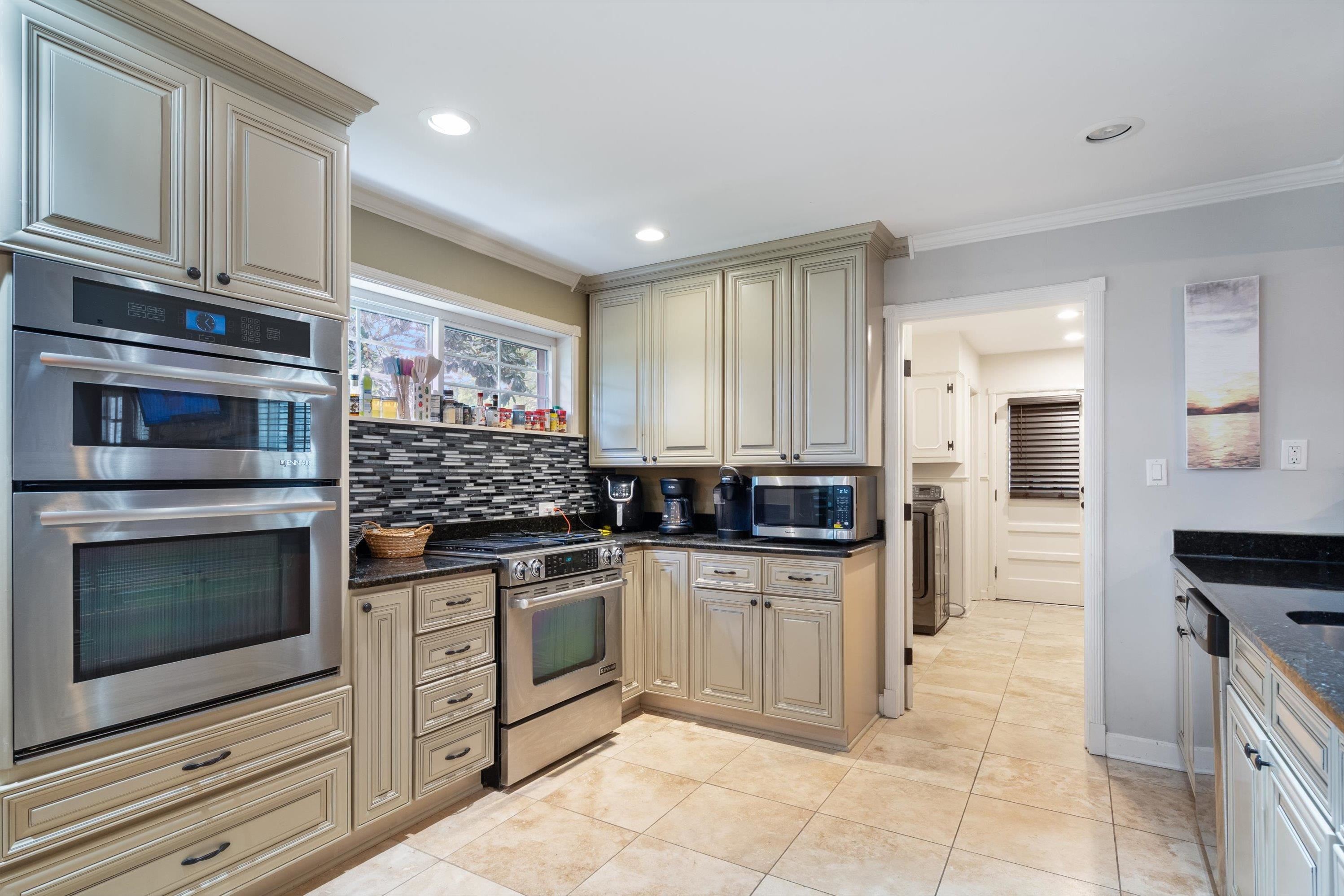839 Reddoch Street Memphis, TN 38119 - Photo 9 of 36 a kitchen with stainless steel appliances granite countertop a stove and cabinets