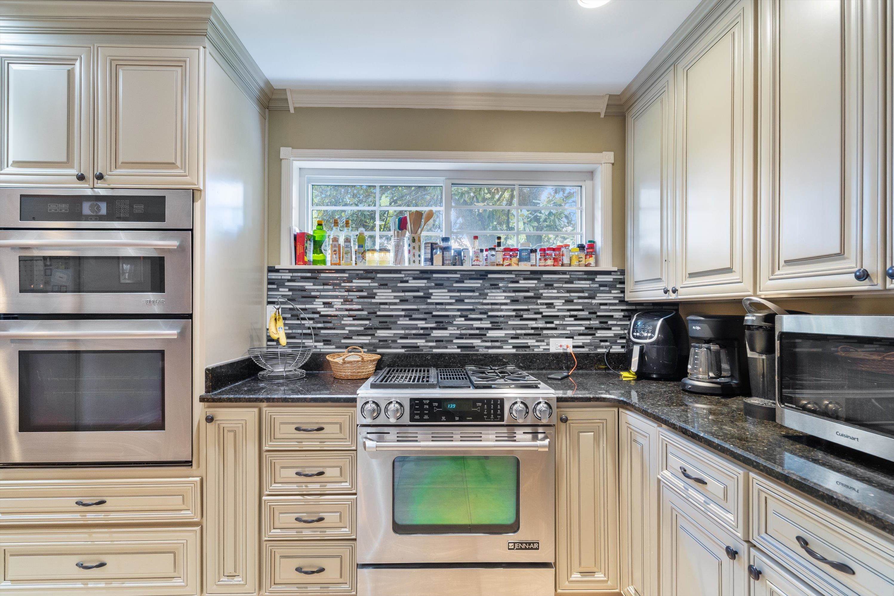839 Reddoch Street Memphis, TN 38119 - Photo 10 of 36 a kitchen with stainless steel appliances granite countertop a stove and a microwave