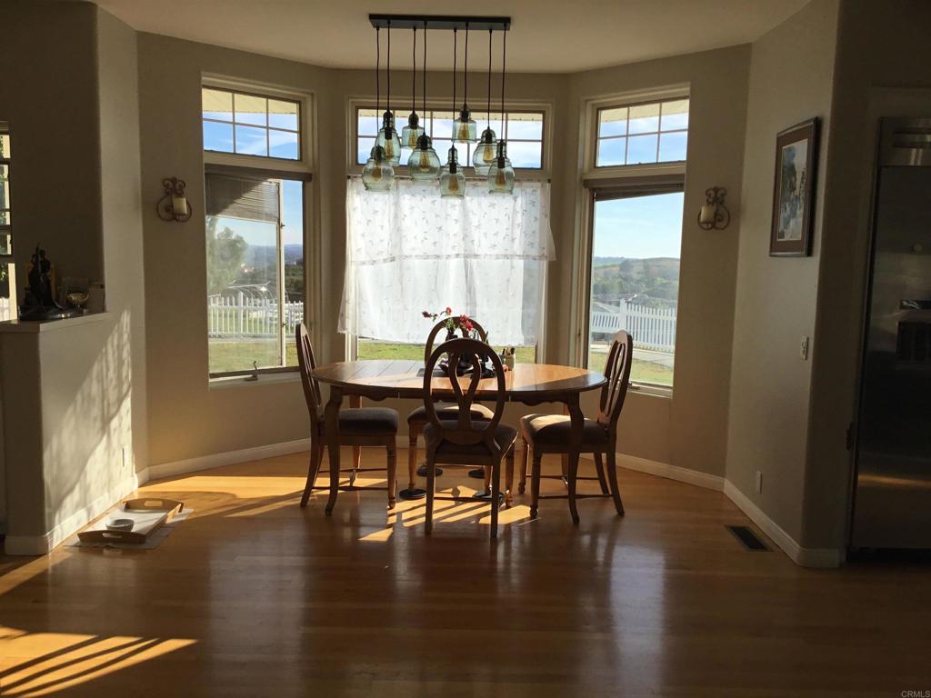 622 Rancho Del Cerro Fallbrook, CA 92028 - Photo 13 of 58 a view of a dining room with furniture window and wooden floor