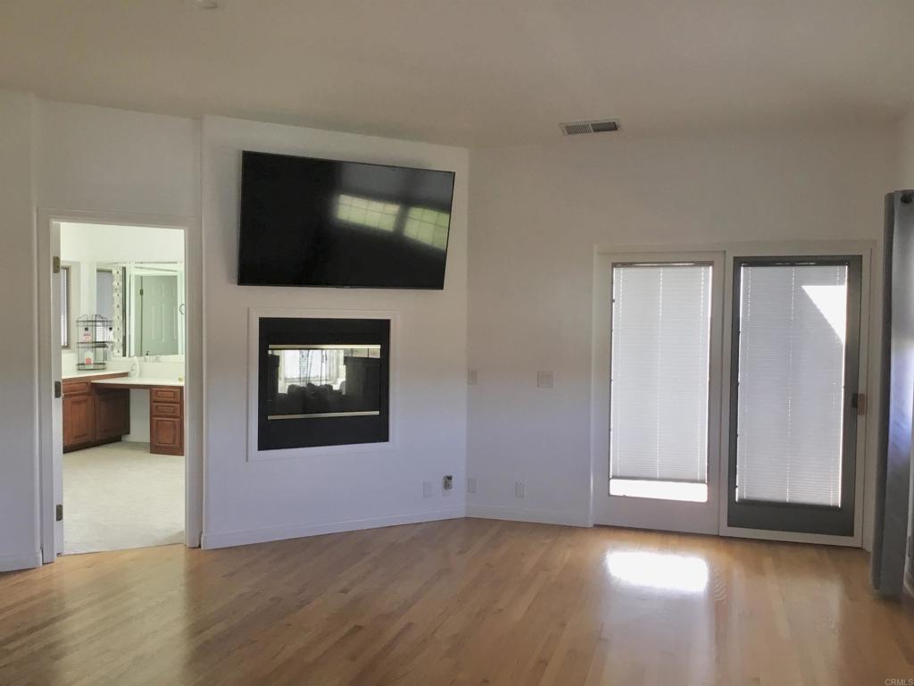 622 Rancho Del Cerro Fallbrook, CA 92028 - Photo 15 of 58 a view of a livingroom with wooden floor and a flat screen tv