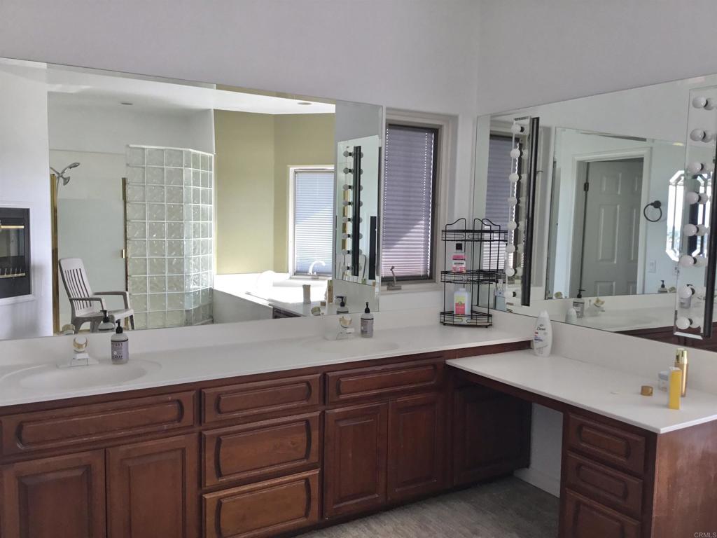 622 Rancho Del Cerro Fallbrook, CA 92028 - Photo 16 of 58 a bathroom with double vanity sinks and a large mirror