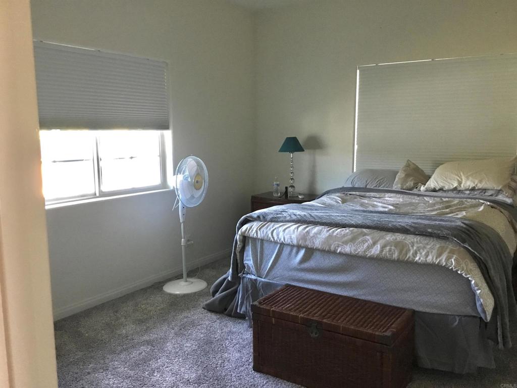 622 Rancho Del Cerro Fallbrook, CA 92028 - Photo 22 of 58 a bedroom with a bed a table and chair