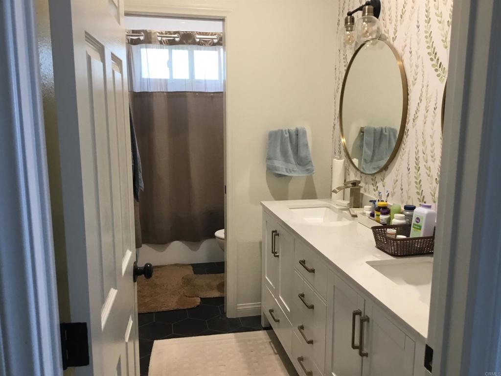 622 Rancho Del Cerro Fallbrook, CA 92028 - Photo 25 of 58 a bathroom with a sink a toilet and a mirror