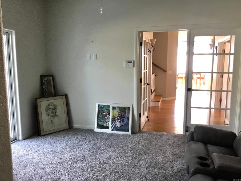 622 Rancho Del Cerro Fallbrook, CA 92028 - Photo 27 of 58 a view of an empty room with a fireplace and a window