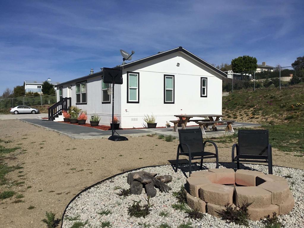 622 Rancho Del Cerro Fallbrook, CA 92028 - Photo 48 of 58 a view of a backyard with table and chairs flat flat screen tv