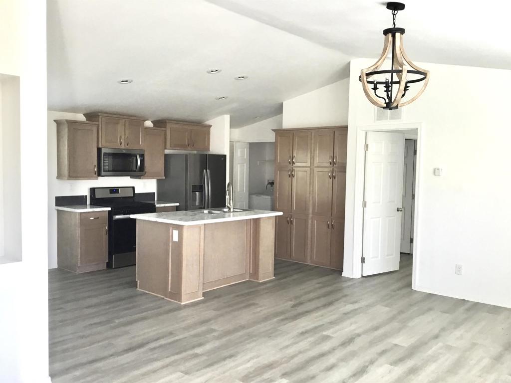 622 Rancho Del Cerro Fallbrook, CA 92028 - Photo 50 of 58 a kitchen with a refrigerator and a stove top oven