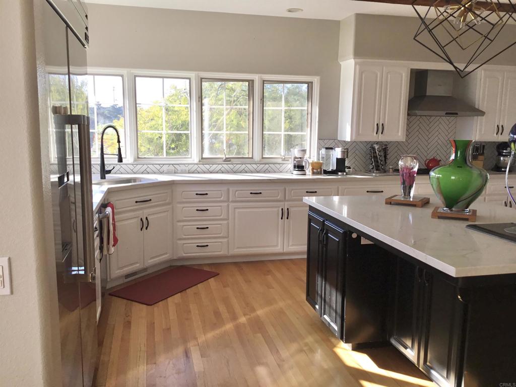 622 Rancho Del Cerro Fallbrook, CA 92028 - Photo 9 of 58 a kitchen with a sink stove and cabinets