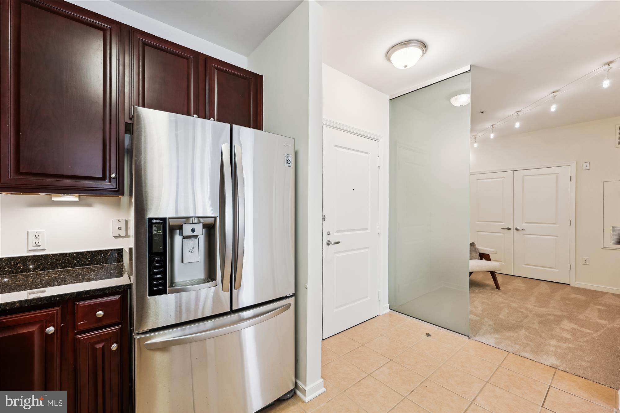 8045 Newell Street, Unit 319 Silver Spring, MD 20910 - Photo 12 of 66 a kitchen with kitchen island a counter top space cabinets and stainless steel appliances