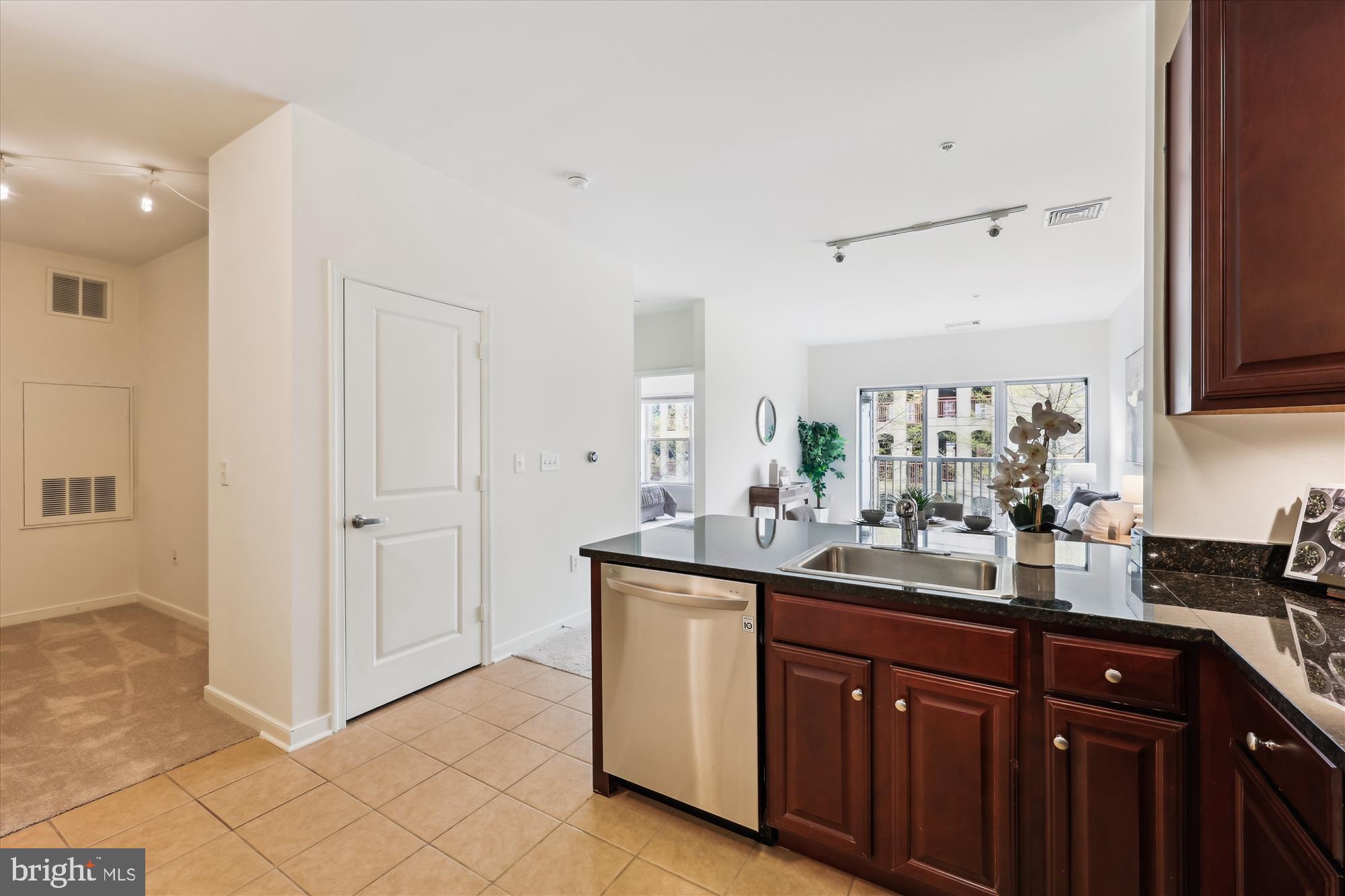 8045 Newell Street, Unit 319 Silver Spring, MD 20910 - Photo 14 of 66 a kitchen with stainless steel appliances granite countertop a sink and cabinets