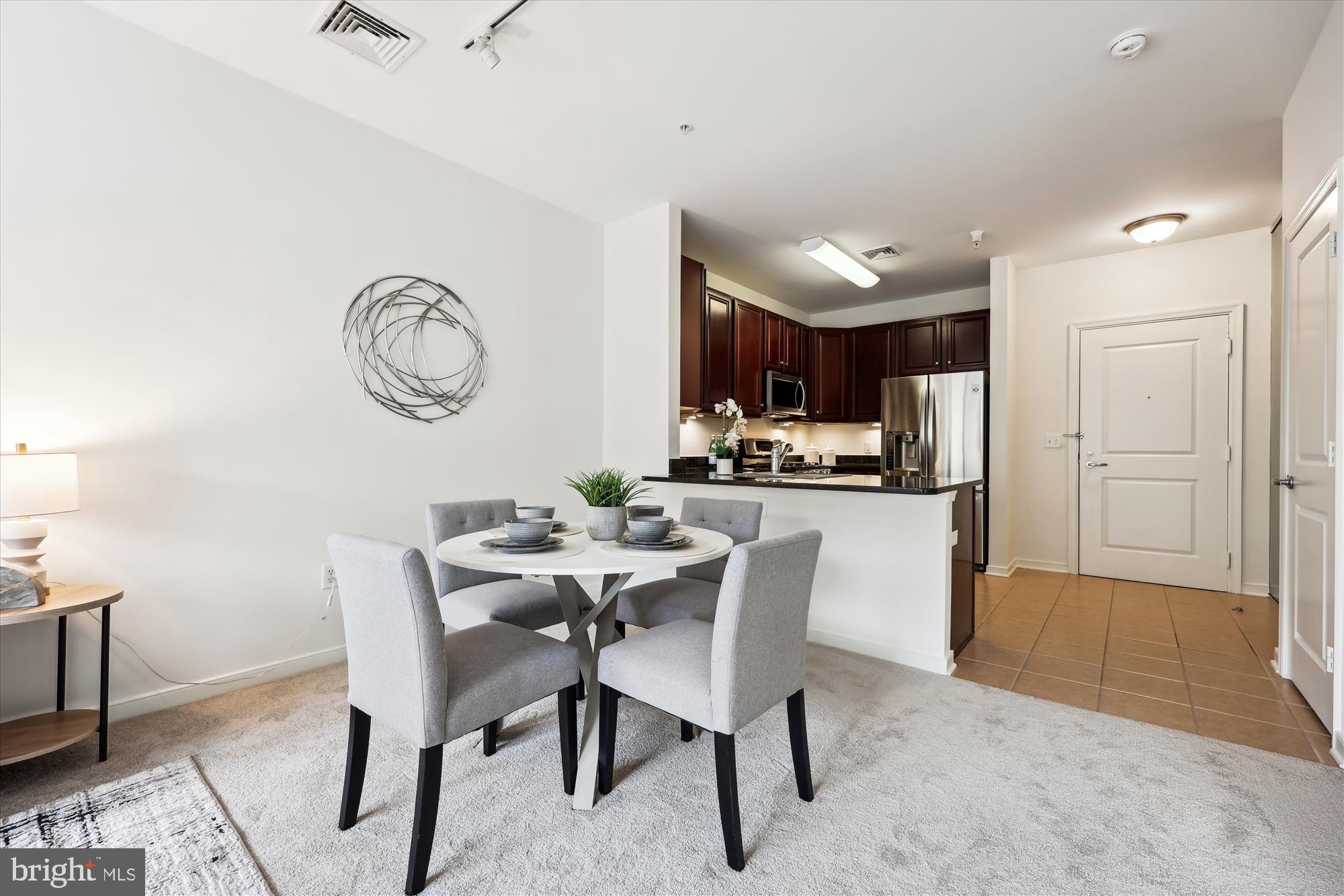 8045 Newell Street, Unit 319 Silver Spring, MD 20910 - Photo 15 of 66 a view of a dining room with furniture