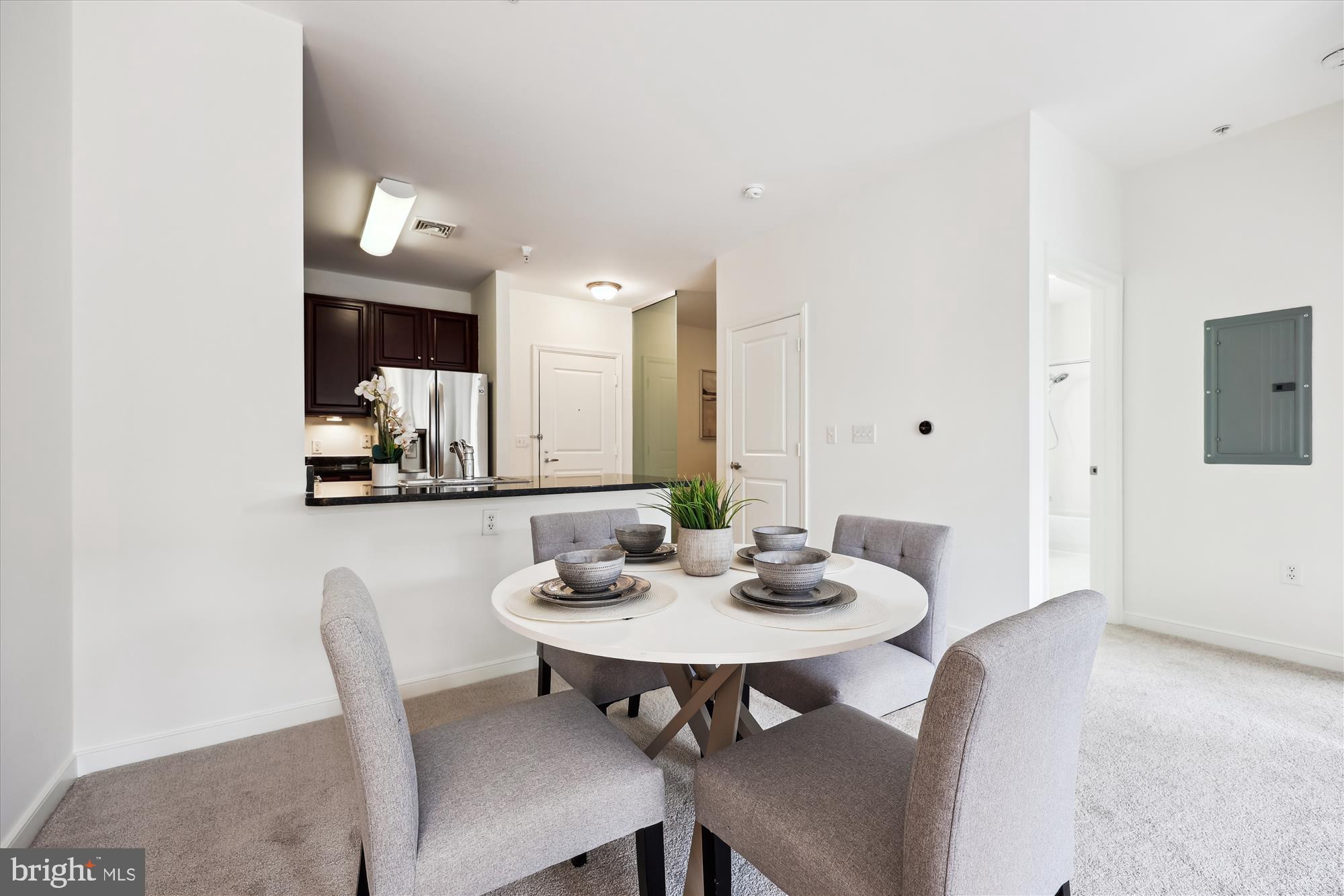 8045 Newell Street, Unit 319 Silver Spring, MD 20910 - Photo 16 of 66 a view of a dining room with furniture and wooden floor
