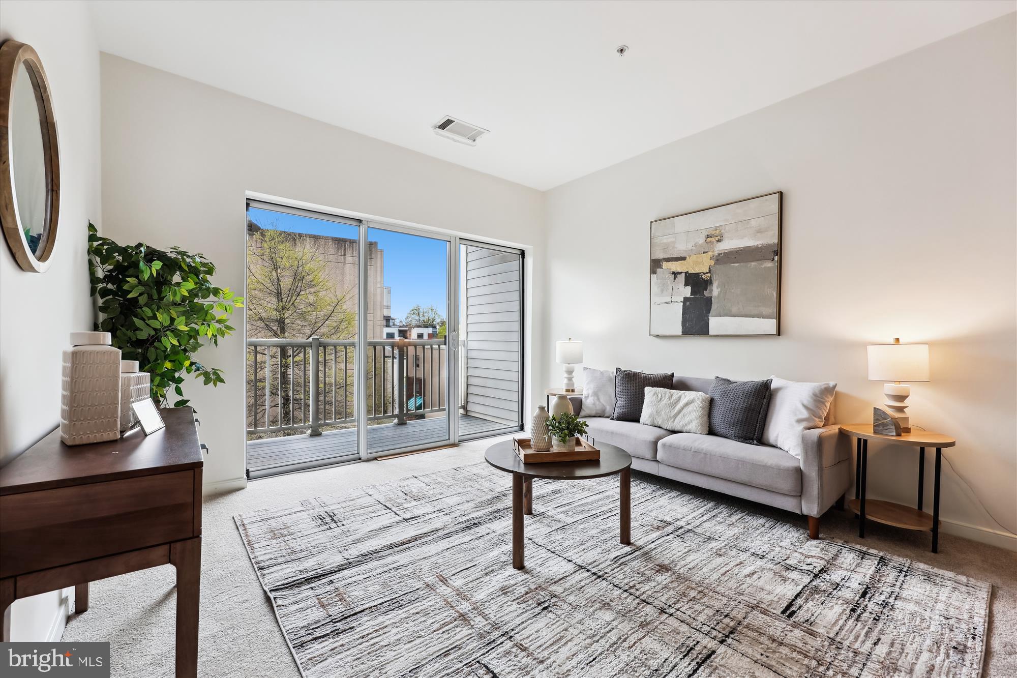8045 Newell Street, Unit 319 Silver Spring, MD 20910 - Photo 19 of 66 a living room with furniture and a potted plant