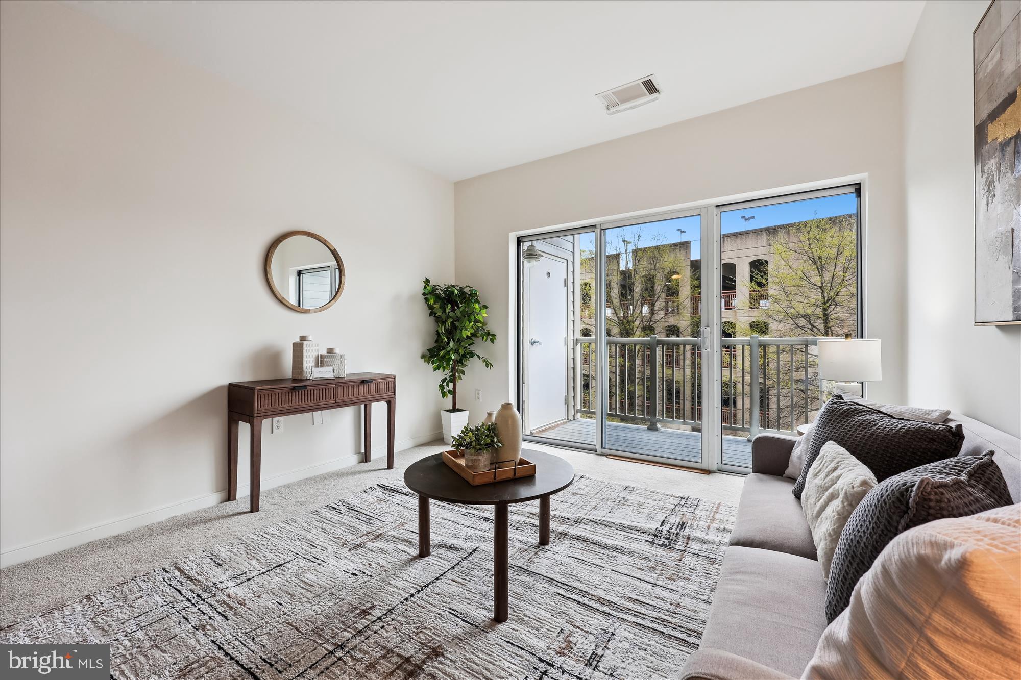 8045 Newell Street, Unit 319 Silver Spring, MD 20910 - Photo 20 of 66 a living room with furniture a table and a large window