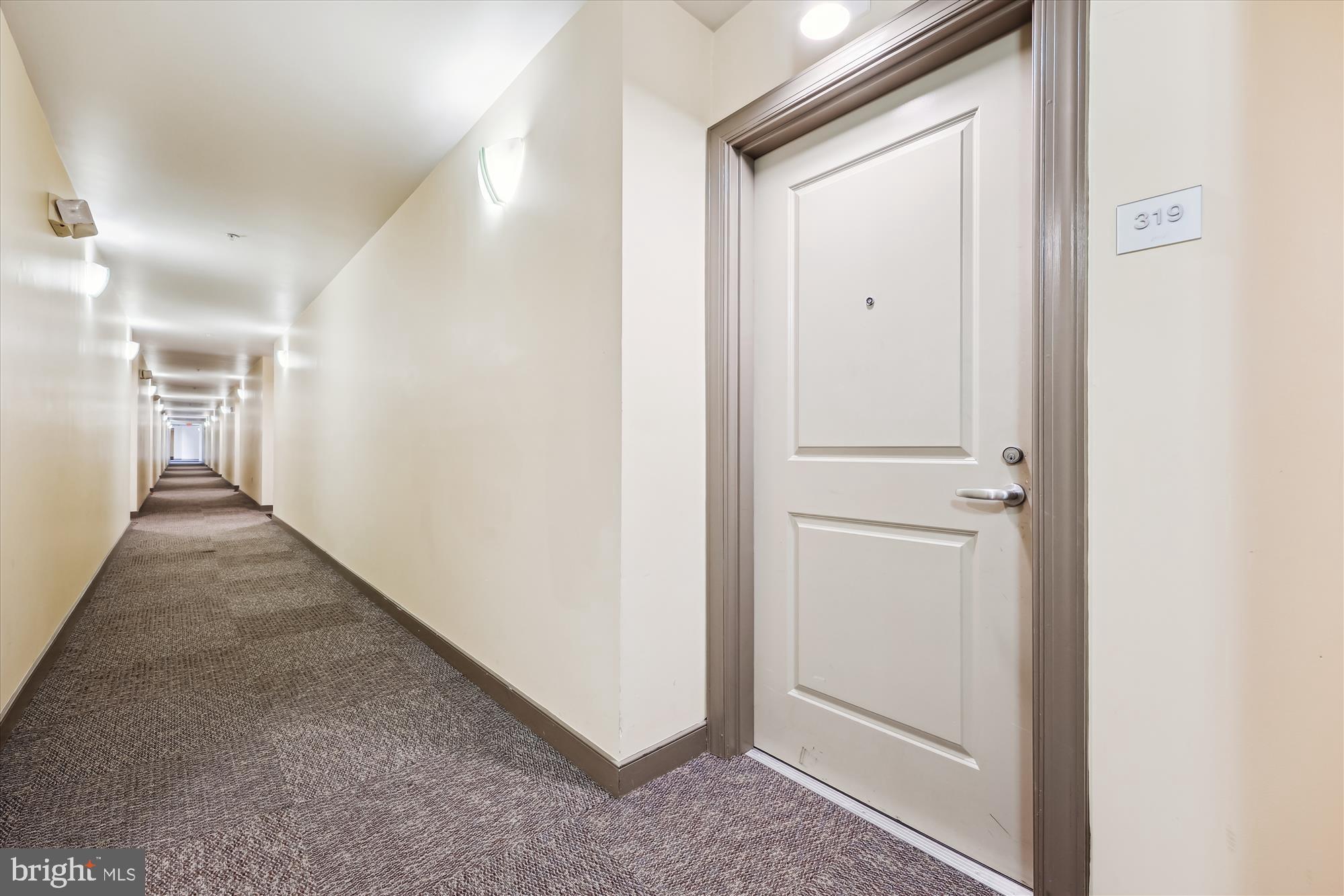 8045 Newell Street, Unit 319 Silver Spring, MD 20910 - Photo 2 of 66 a view of a hallway with wooden floor