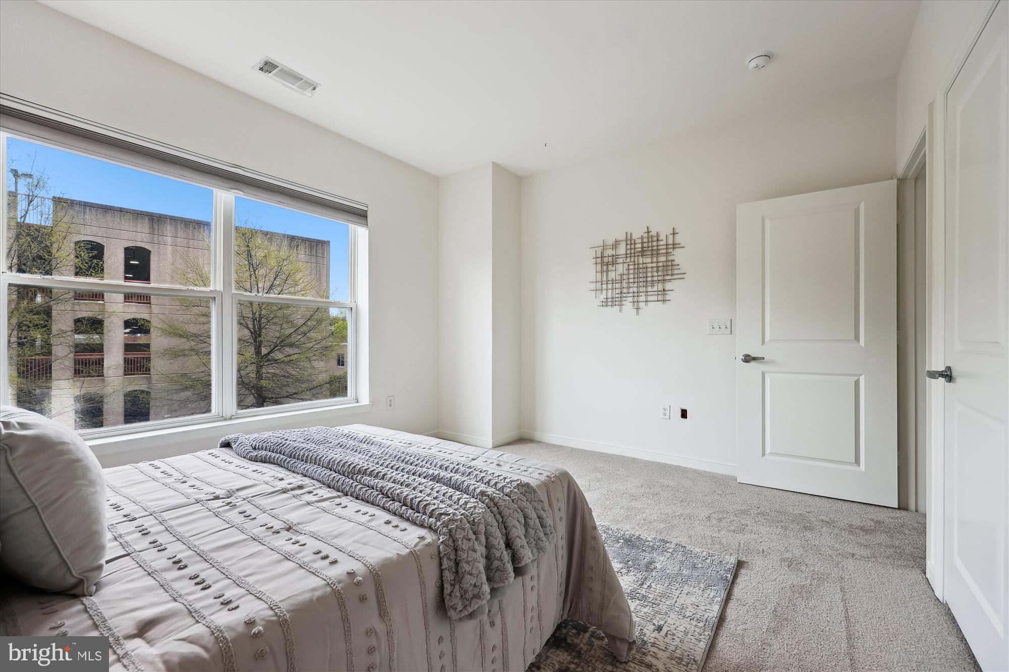 8045 Newell Street, Unit 319 Silver Spring, MD 20910 - Photo 29 of 66 a bedroom with a bed and a window