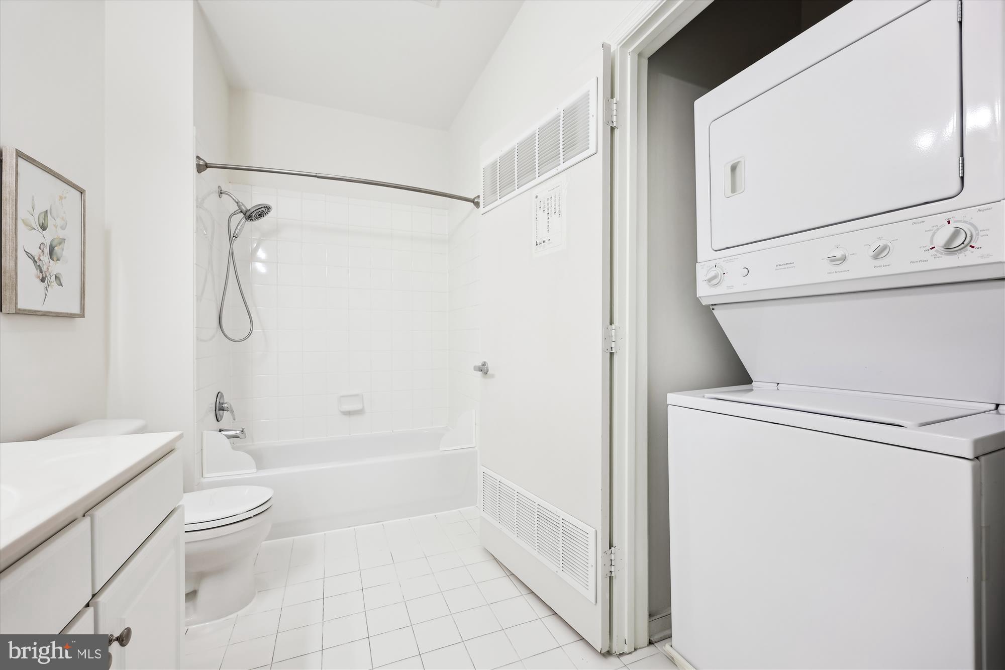 8045 Newell Street, Unit 319 Silver Spring, MD 20910 - Photo 34 of 66 a bathroom with a granite countertop white toilet a sink a vanity and shower