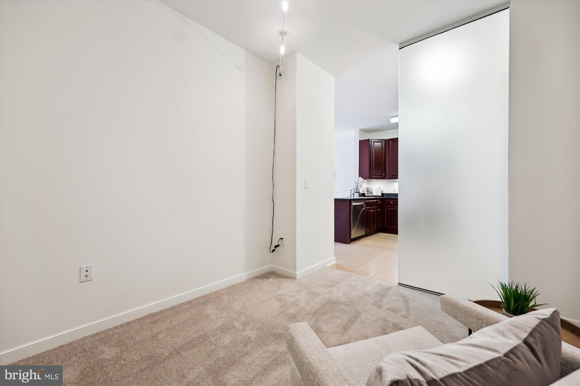 8045 Newell Street, Unit 319 Silver Spring, MD 20910 - Photo 6 of 66 a living room with furniture and a flat screen tv