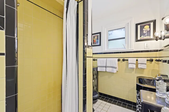 a view of a patio with couches table and chairs under an umbrella with a garden