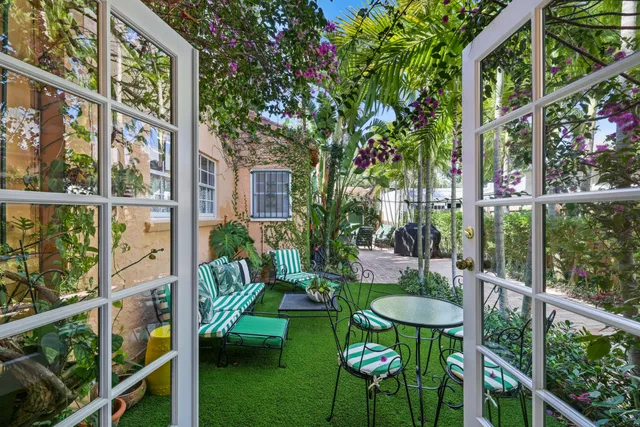 a view of a chair and table in backyard of the house