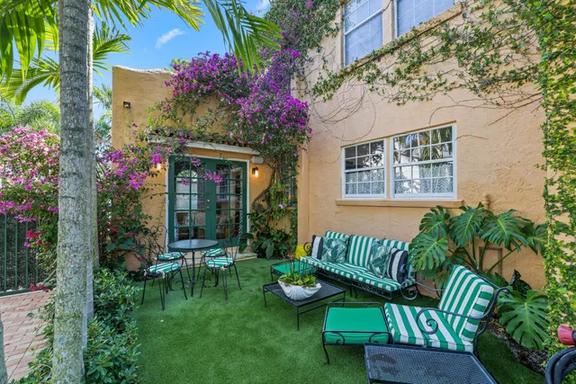 a view of a chair and table in the garden