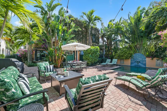 a kitchen with a dining table chairs refrigerator and microwave