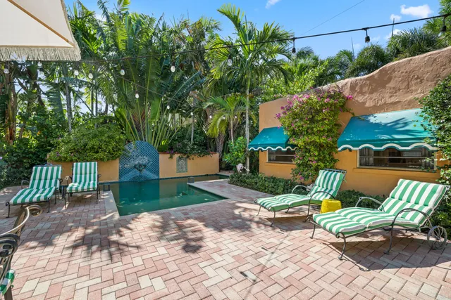 a living room with furniture or chandelier and a wooden floor