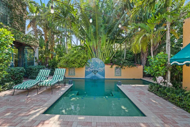 a bedroom with a bed and a lamp on a dresser
