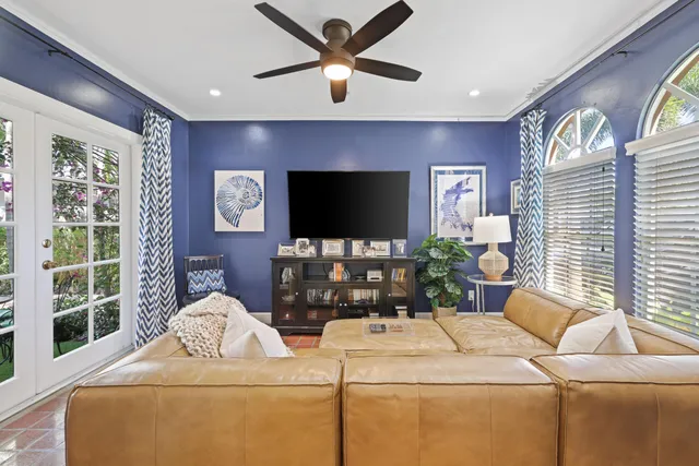 a dining room with furniture a chandelier and wooden floor